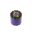 large metal purple herb grinder with rasta leaf